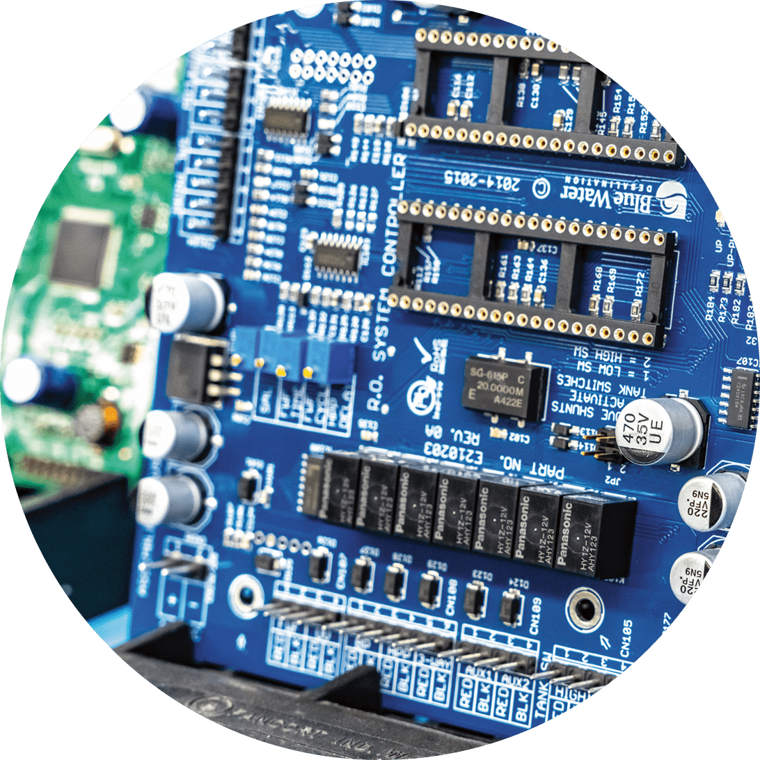 Blue circuit board with electronic components.