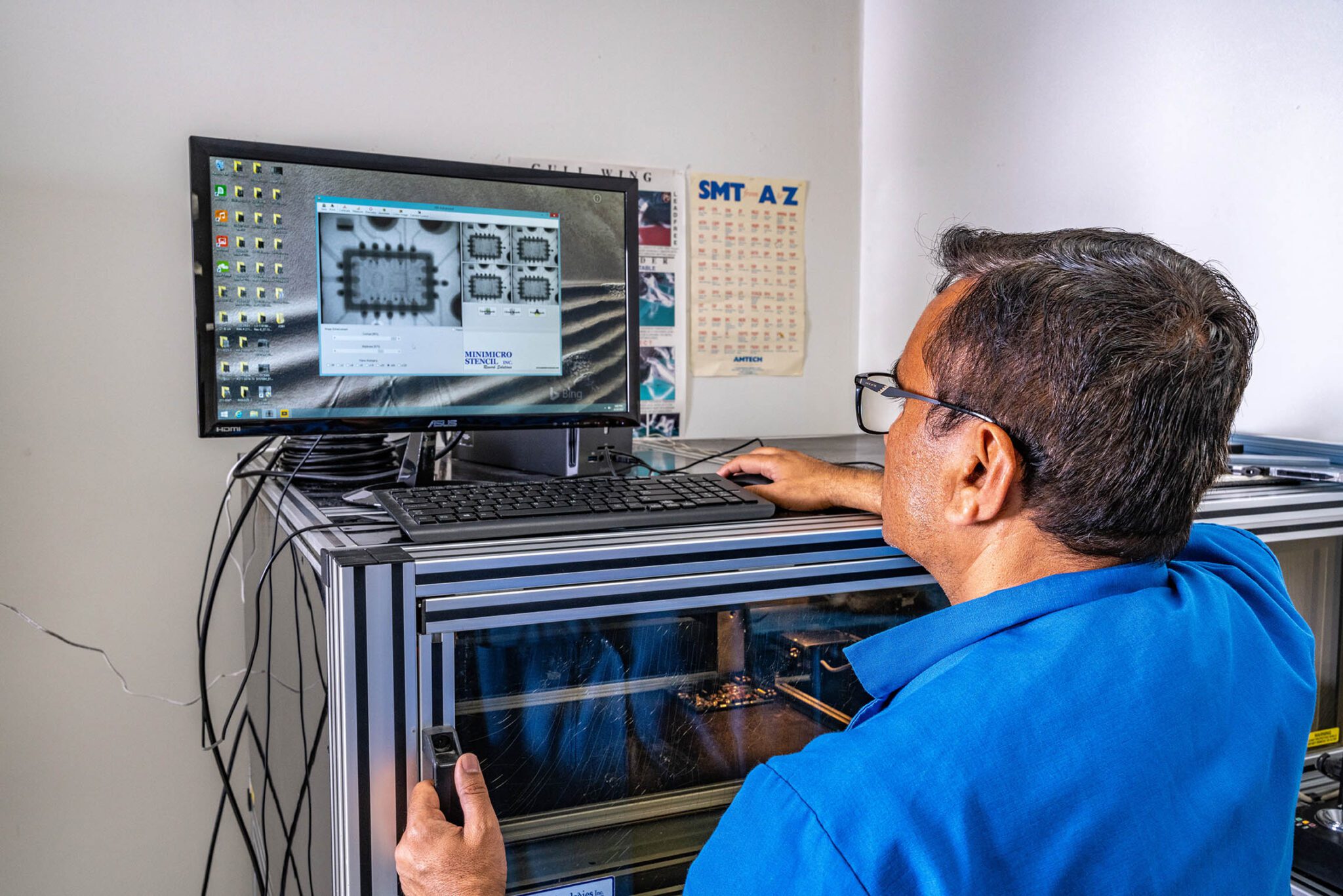 Technician analyzing circuit design on computer.