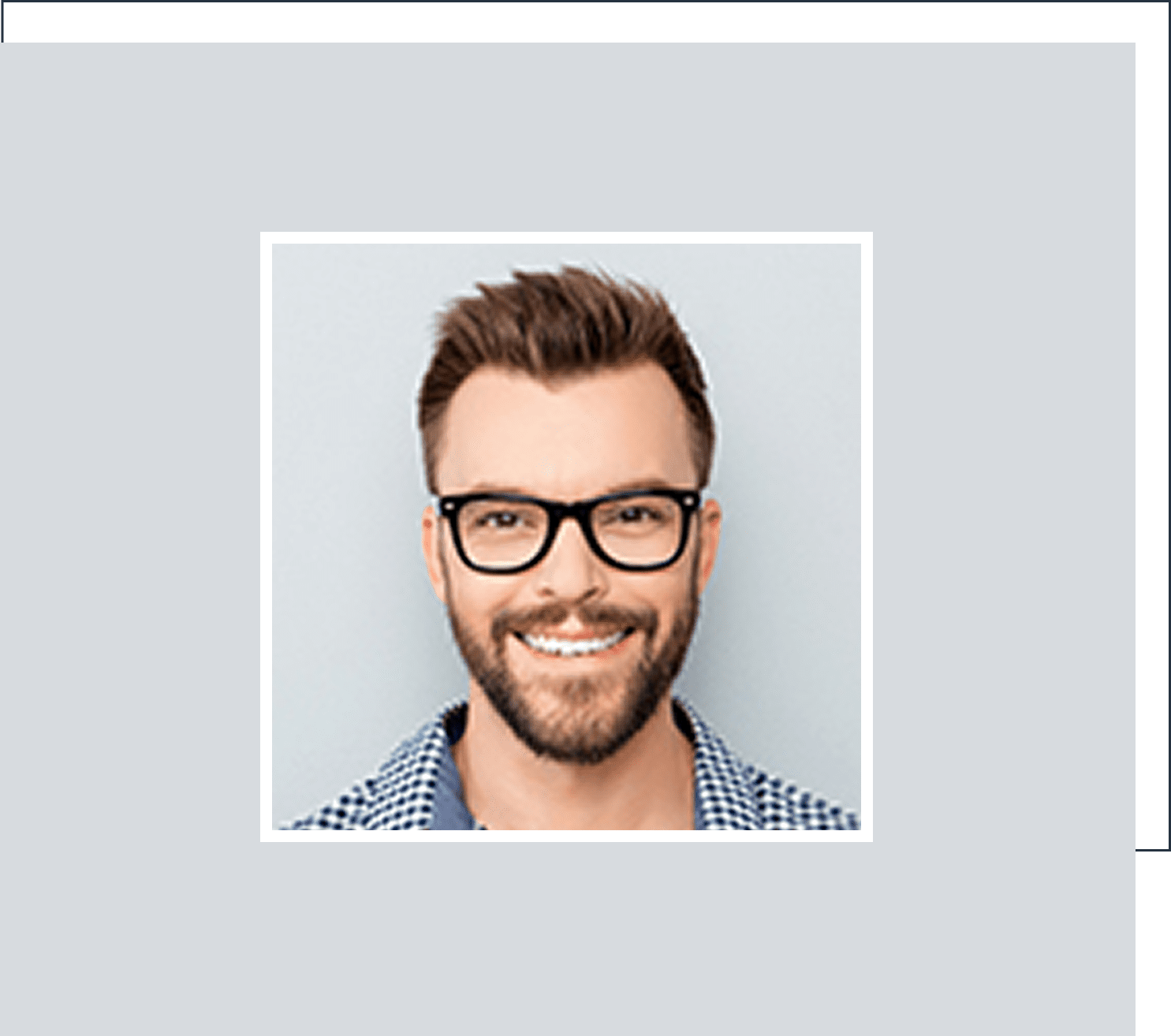 Man smiling, wearing glasses and checkered shirt.