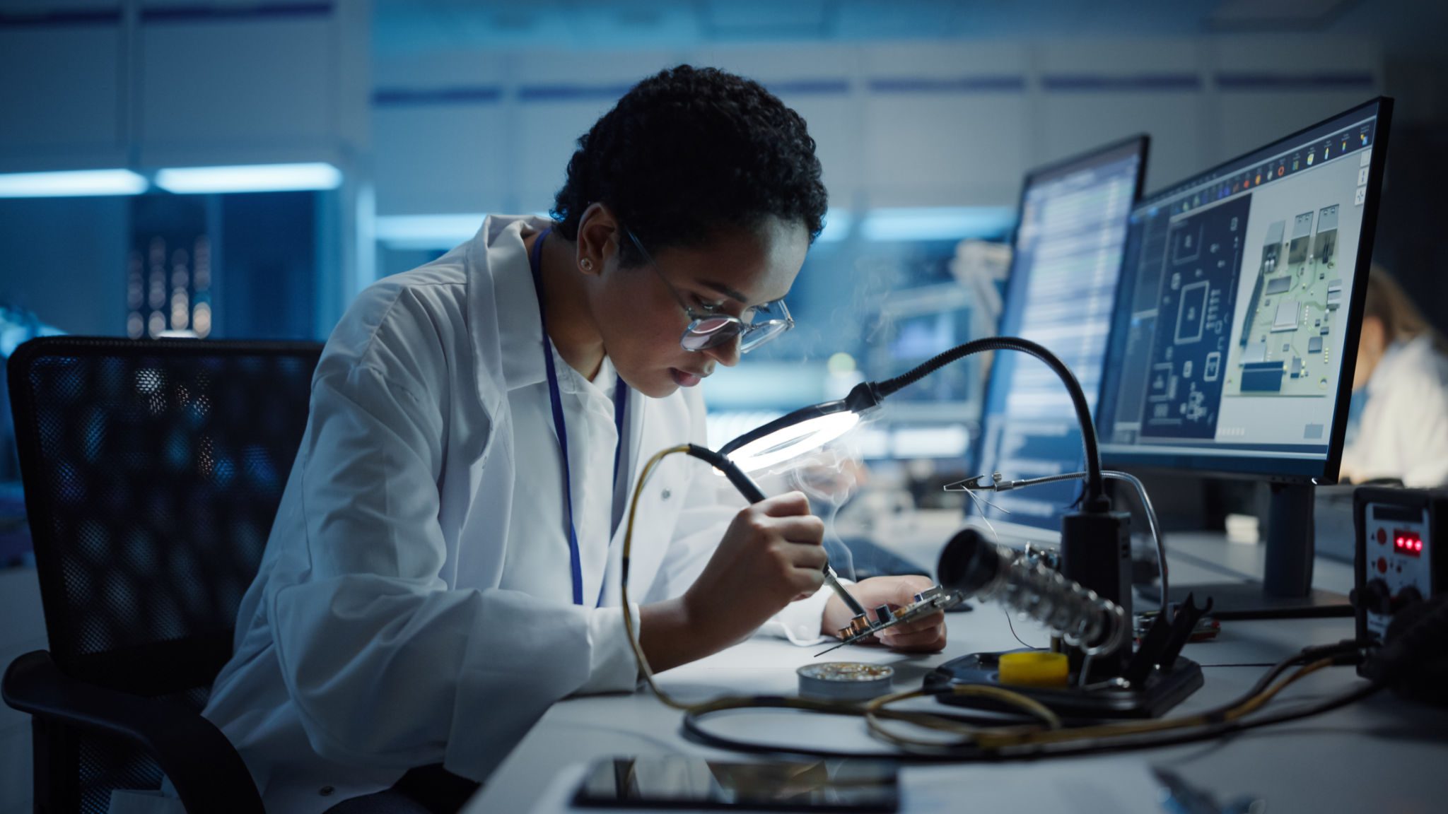 Scientist working on electronics in a lab.