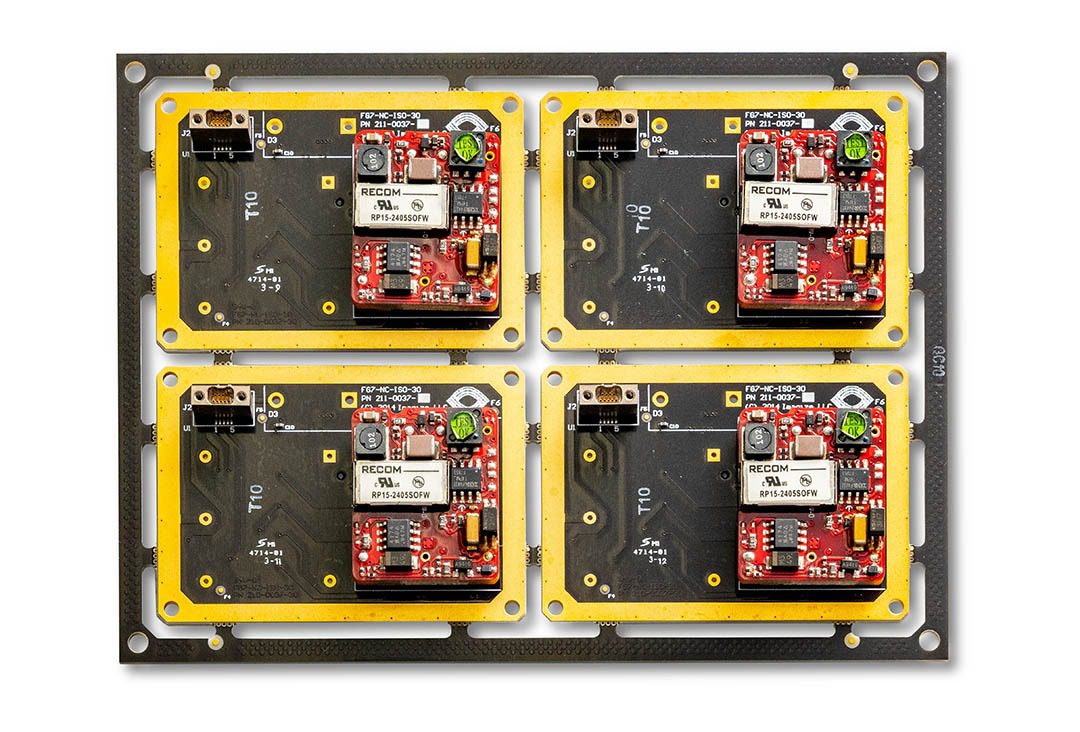 Four electronic circuit boards on a panel.