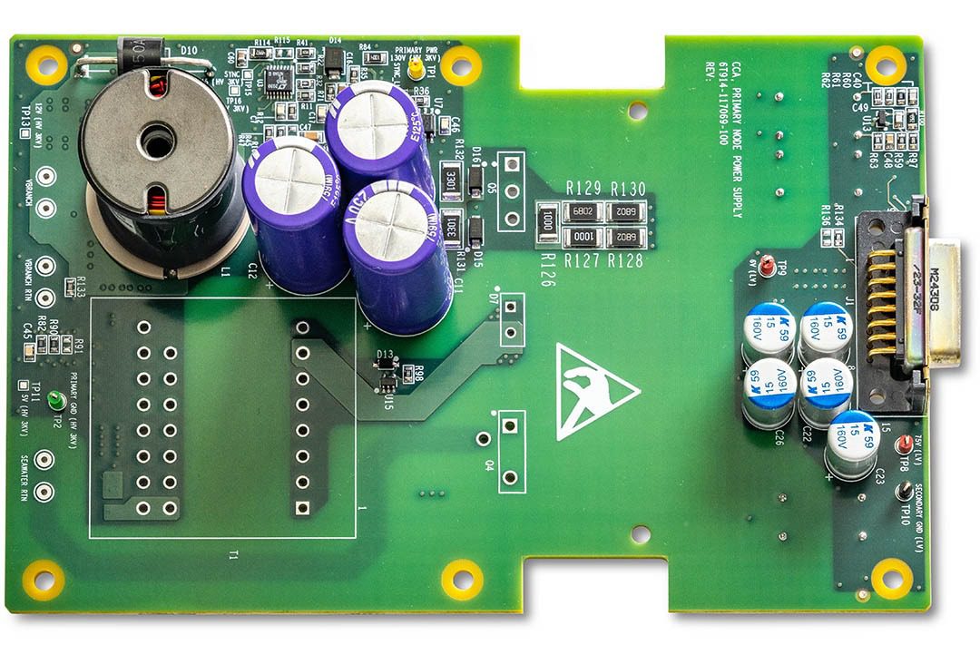 Green electronic circuit board with capacitors.