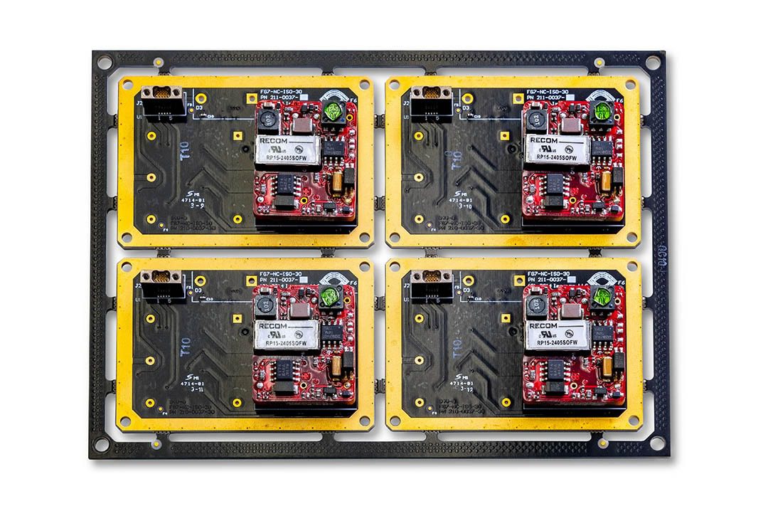 Four electronic circuit boards on a panel.
