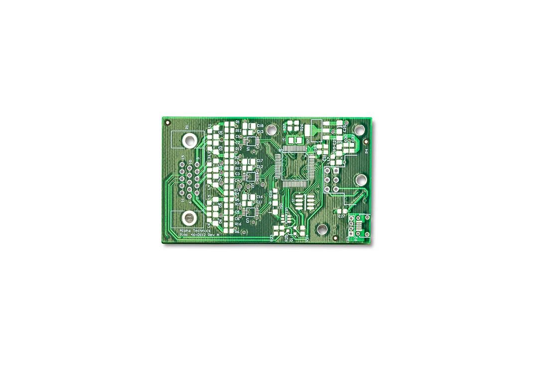 Green electronic circuit board with various components.