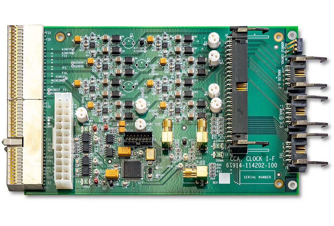 Green electronic circuit board with various components.