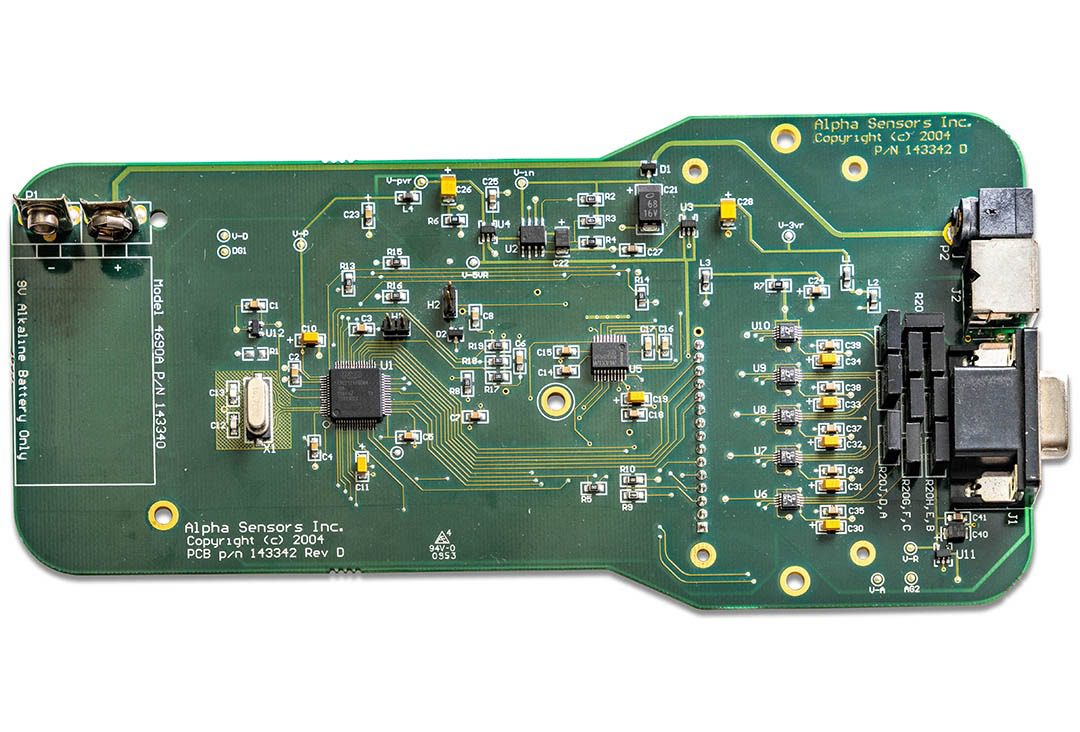 Green electronic circuit board with various components.