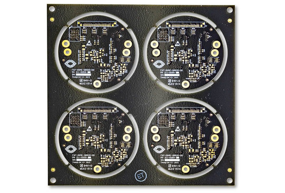 Four circular circuit boards on black panel.