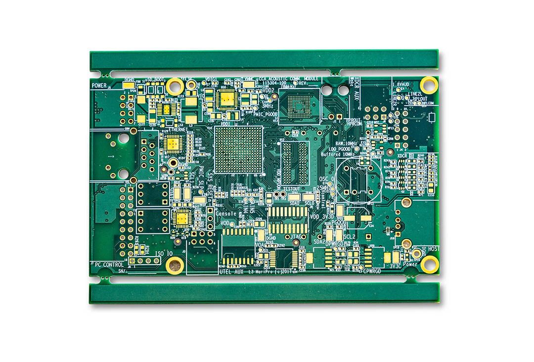 Green electronic circuit board with various components.