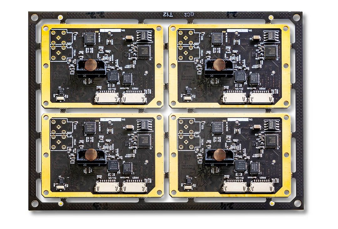 Four black circuit boards on rectangular panel.