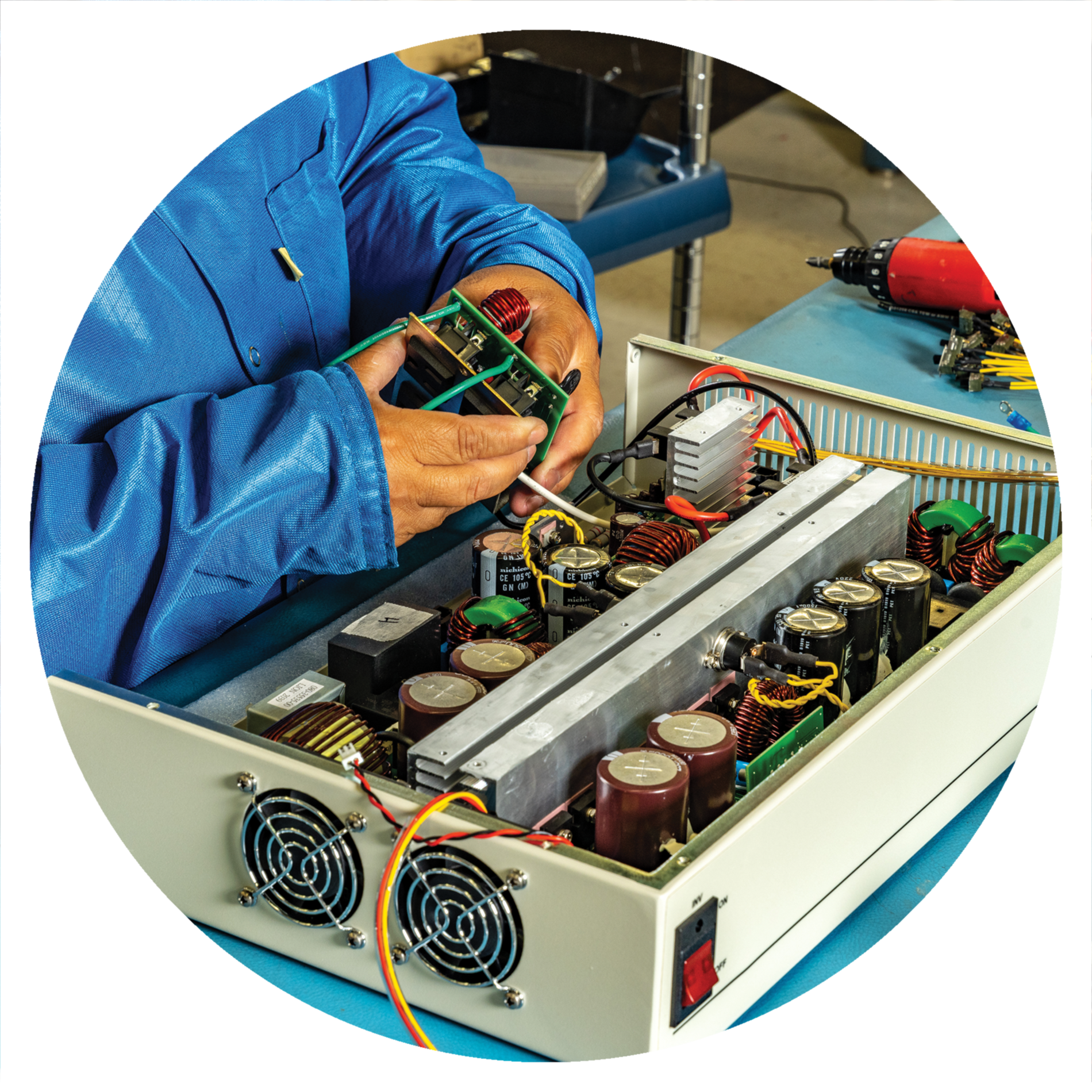Technician assembling circuit board inside open power supply