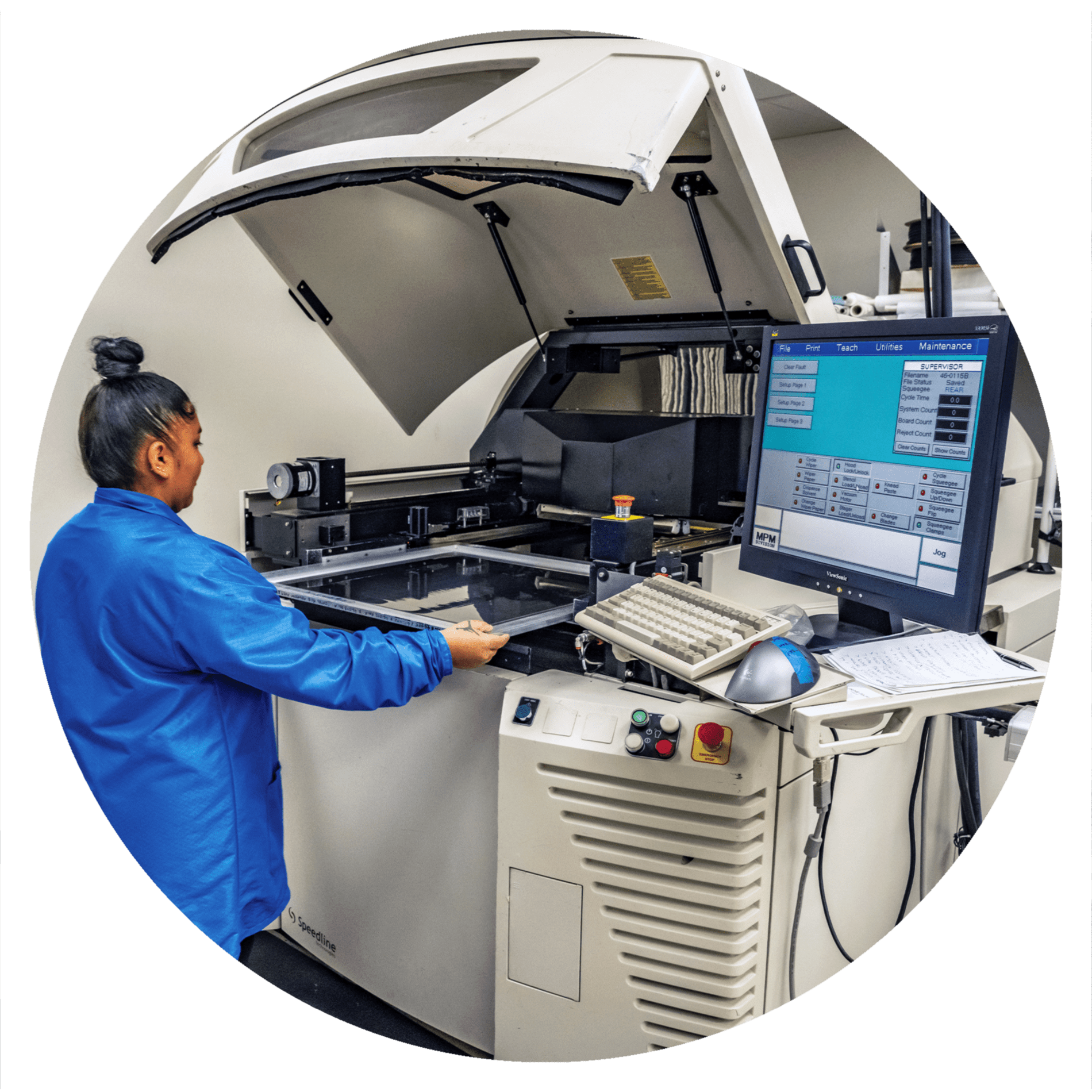 Technician operating automated PCB assembly machine