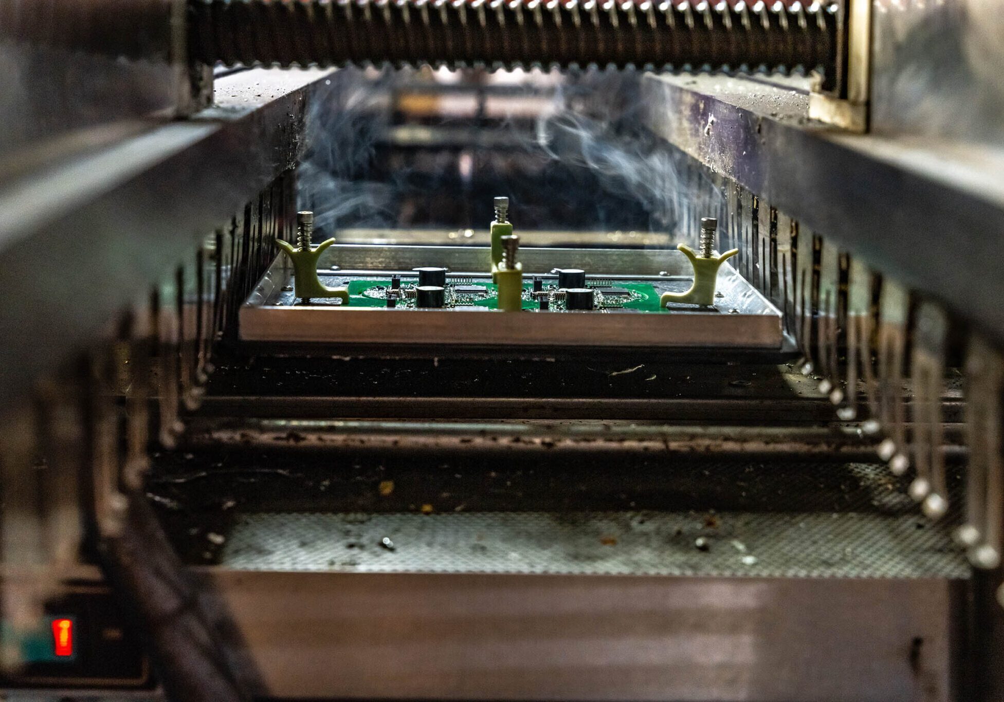 Circuit board in manufacturing process, under machinery.