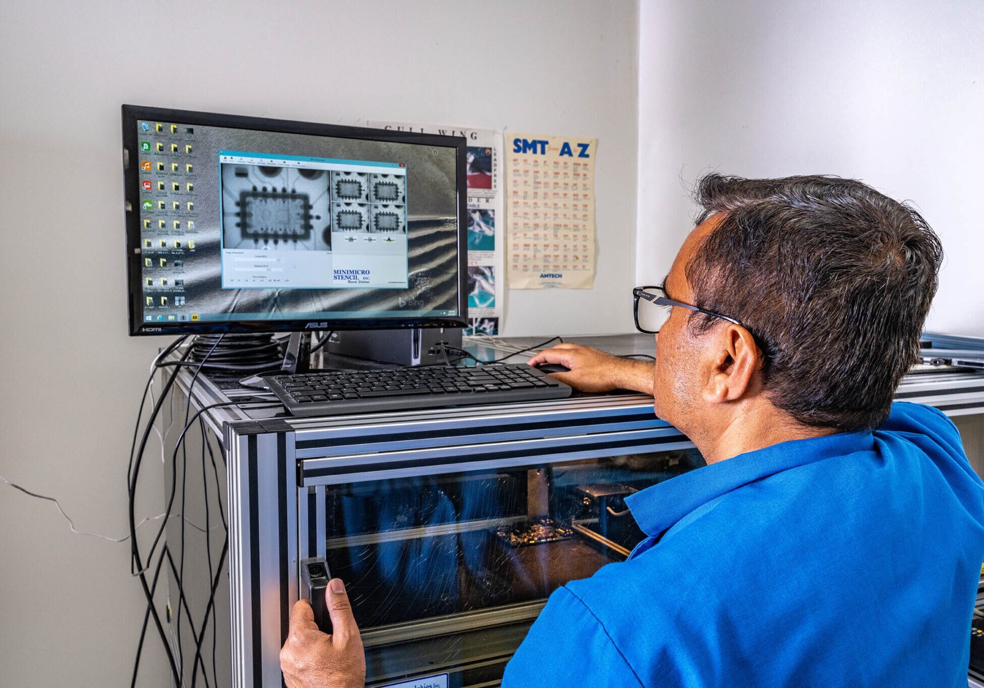 Technician analyzing circuit design on computer.
